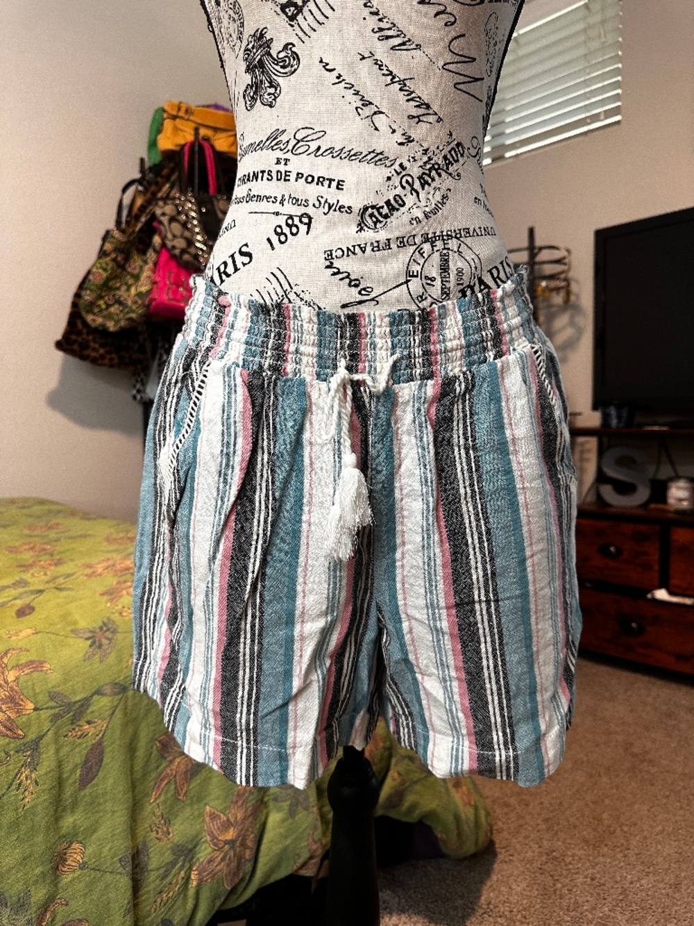 multicoloured striped shorts with drawstring waist and pockets.